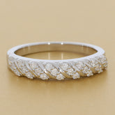 Elegant white diamond sterling silver ring with a twisted design and sparkling accent stones.